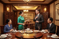 Companion facilitating business dinner with Chinese partners in Shenzhen